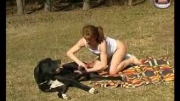 Ginger-haired chick and dark pooch banging in the woods